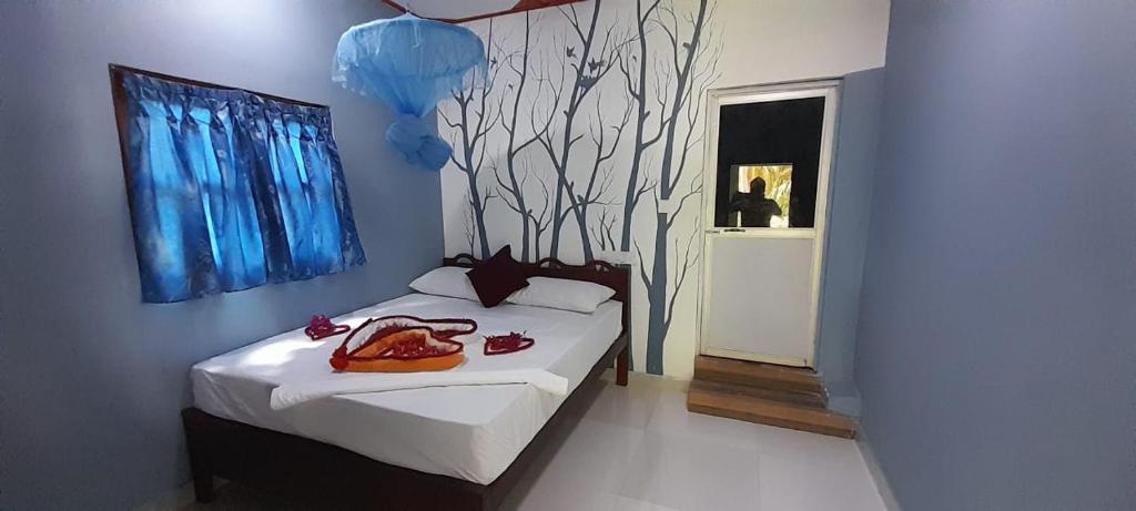 a bedroom with a bed with a bag on it at DA GREA NATURAL BEACH HOTEL in Trincomalee