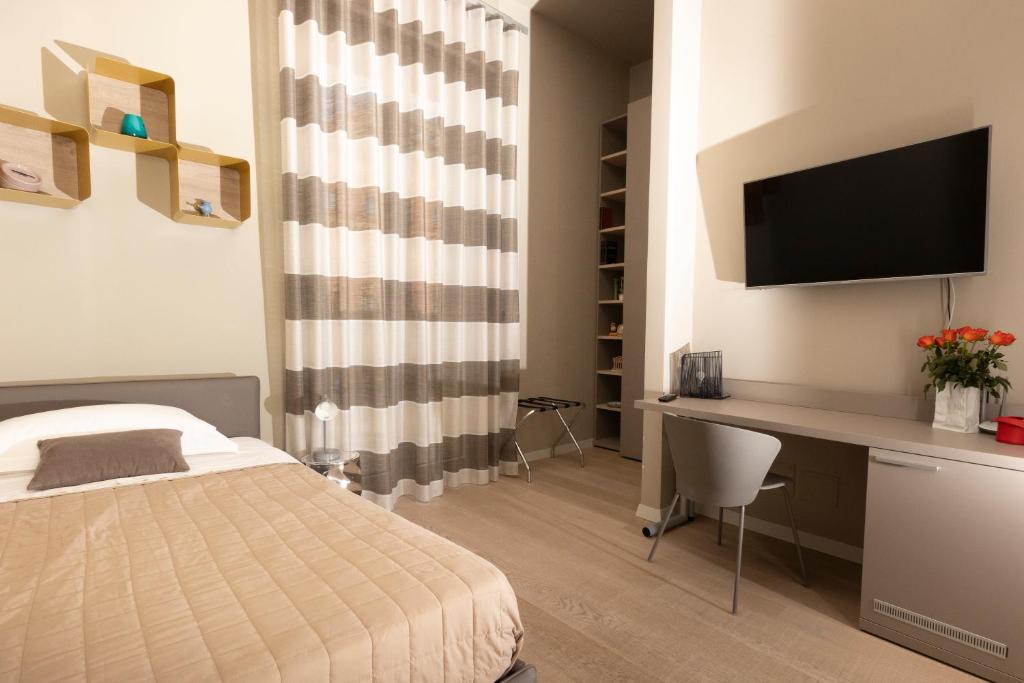 Televízia a/alebo spoločenská miestnosť v ubytovaní Deluxe apartment Milia Agrigento