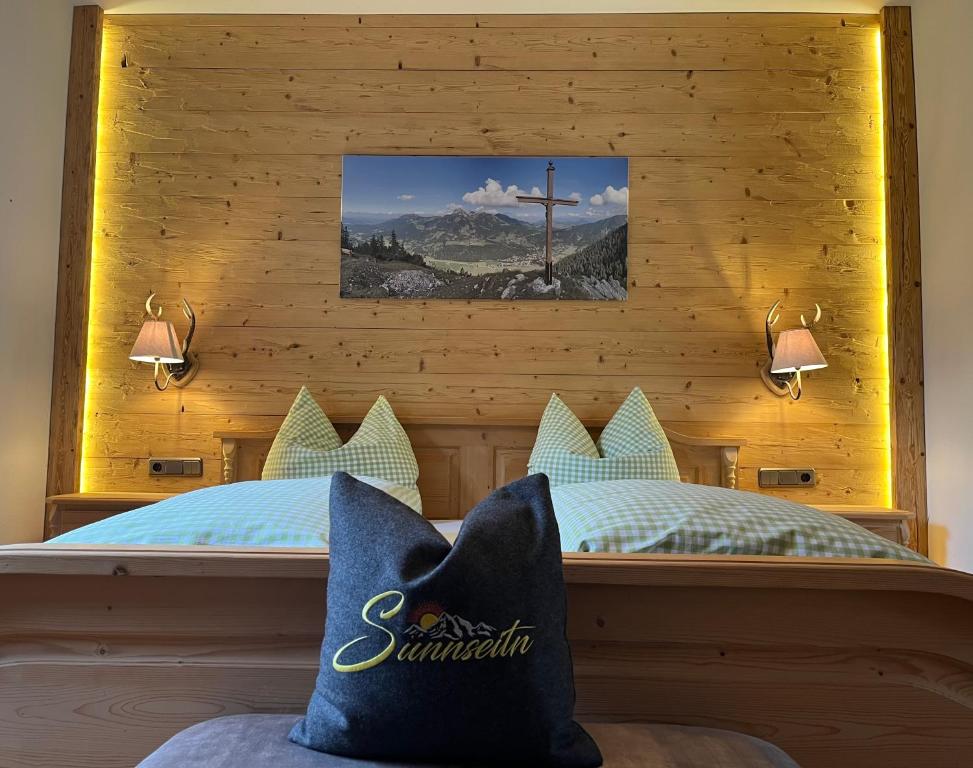 a bedroom with a bed with a cross on the wall at Ferienwohnung Sunnseitn in Bayrischzell