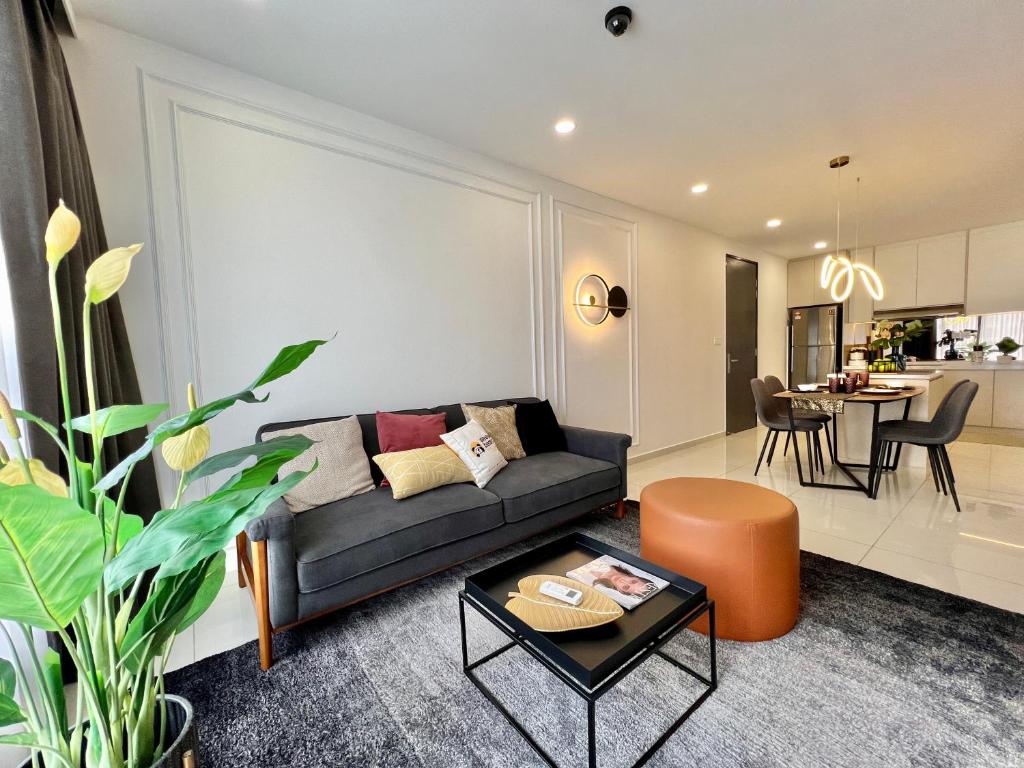 a living room with a couch and a table at Gaia Residence, Gamuda Gardens Rawang by Sleepy Bear in Kuala Lumpur