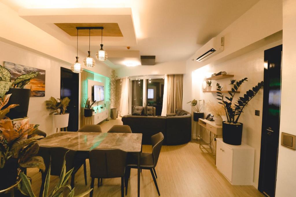a living room and dining room with a table and chairs at Davao Rental - AEON Towers Condo 1BR Suite 1Bathroom with Bathtub, Kitchen, Living Room in Davao City