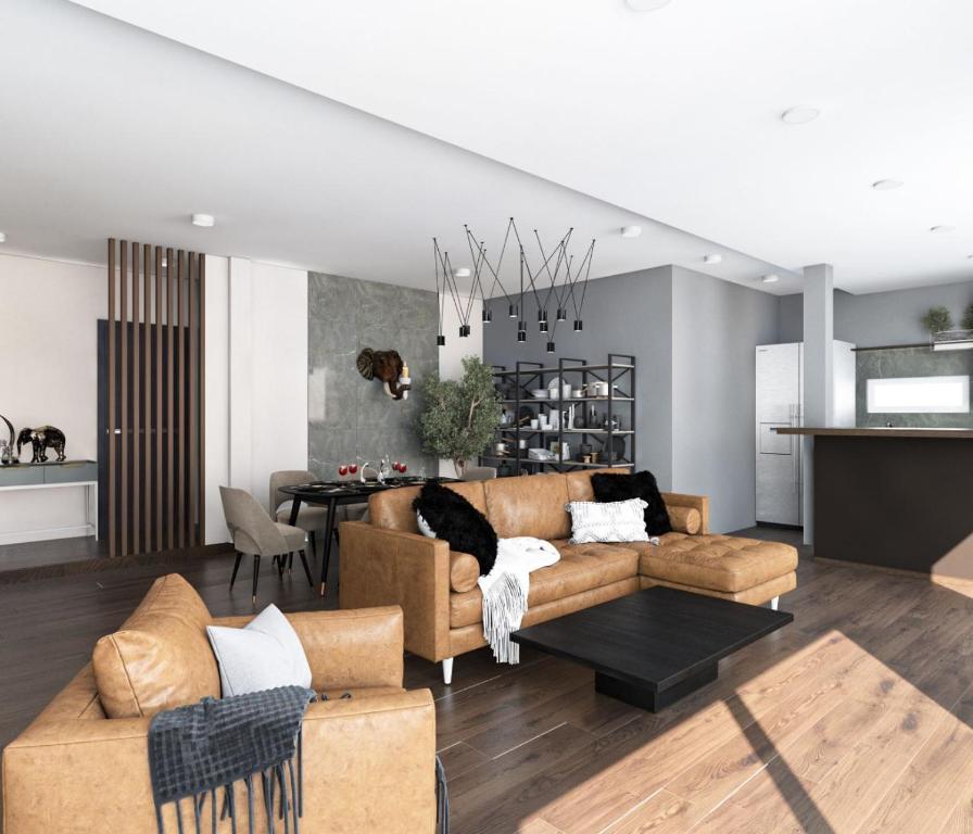 ein Wohnzimmer mit Couch und ein Esszimmer in der Unterkunft Grand Penthouse by Grand Orlov Apart in Patong Beach