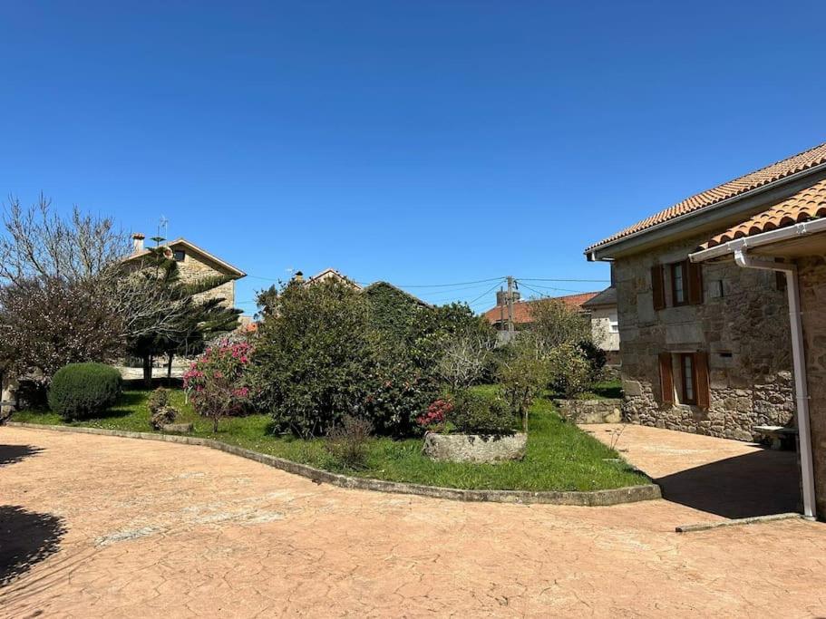 a house with a driveway next to a house at Vibes Coruña- Muxía in Castelo