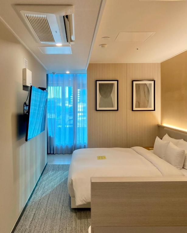 Postel nebo postele na pokoji v ubytování Hound Hotel Busan Station
