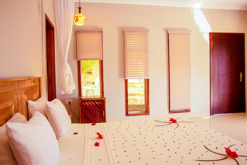 Postel nebo postele na pokoji v ubytování Mandarin Resort Zanzibar