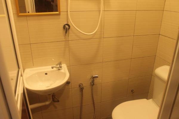 a small bathroom with a sink and a toilet at Meera Heritage Motel in George Town