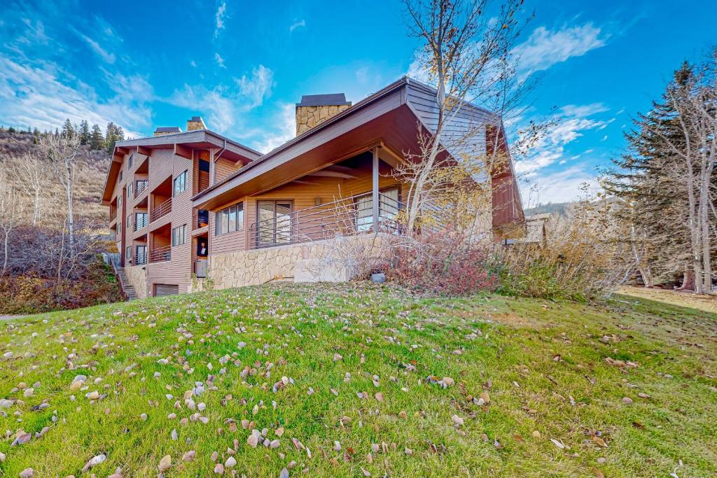 a house on top of a grassy hill at Modern Park City Condo in Park City