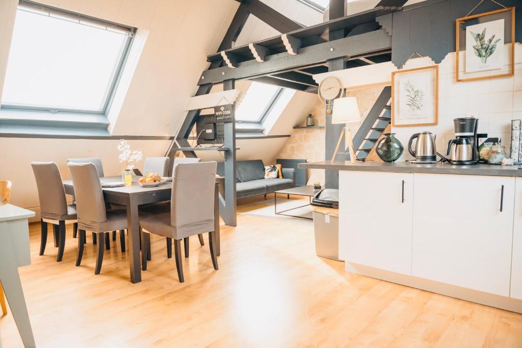 eine Küche und ein Esszimmer mit einem Tisch und Stühlen in der Unterkunft Suite Léonard _ Résidence Isaelle in Bray-Dunes