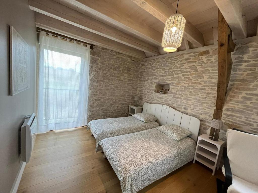 Postel nebo postele na pokoji v ubytování Bergerie du Causse
