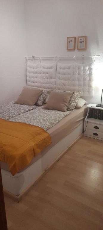 a white bed with pillows on it in a room at Aperi View in Karpathos