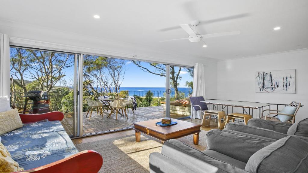 a living room with a view of the ocean at Beach Bay and Bush at Killcare in Killcare