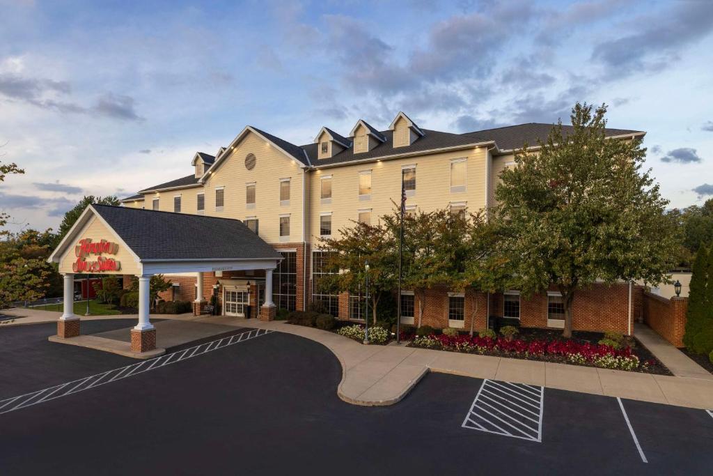 a large building with a gazebo in a parking lot at Hampton Inn & Suites State College at Williamsburg Square in State College