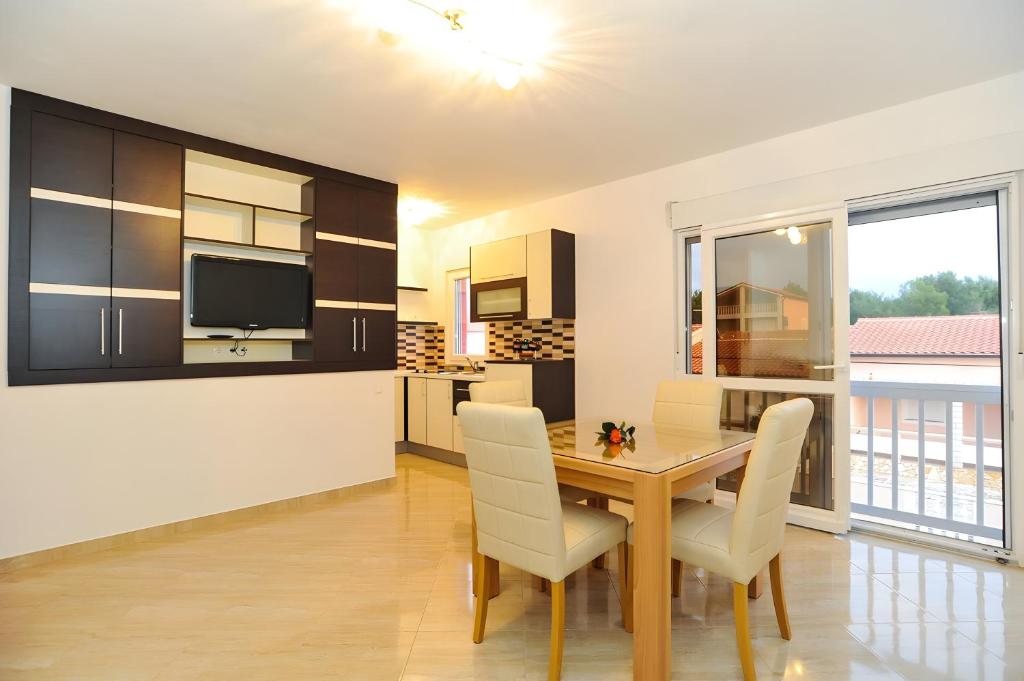 a kitchen and dining room with a table and chairs at Holiday home Tomislav for 12 guests near the beach in Vir