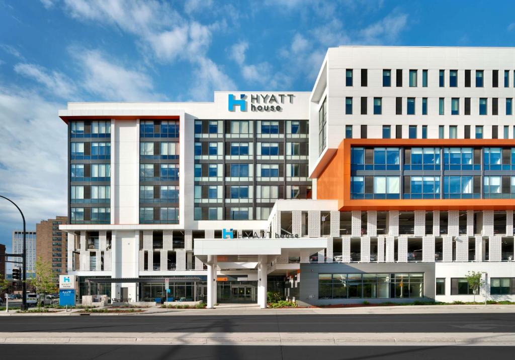 a large white building with a sign on it at Hyatt House Rochester Mayo Clinic Area in Rochester