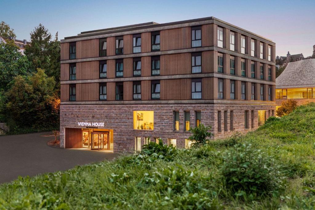 a large brick building on a hill at Vienna House by Wyndham MQ Kronberg in Kronberg im Taunus