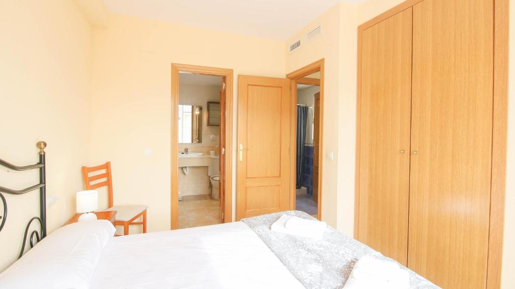 Postel nebo postele na pokoji v ubytování Ático Puerta de Las Marinas