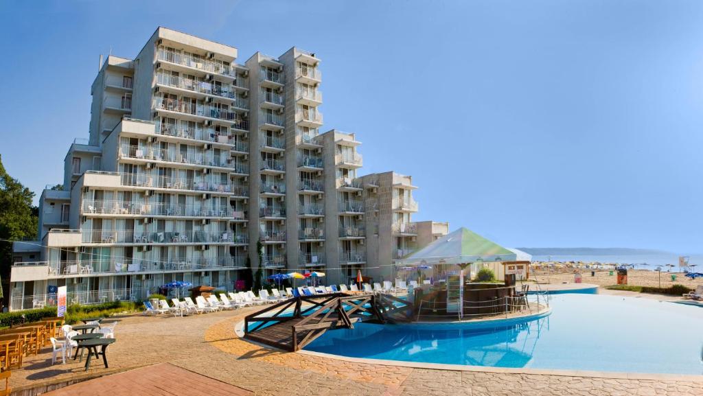 a hotel with a large swimming pool next to a beach at Hotel Elitsa in Albena
