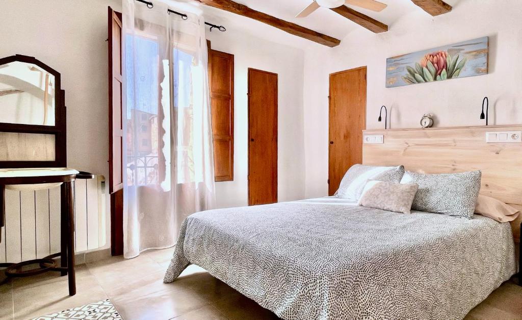 a bedroom with a bed and a window at Ca tia Teresa in Planes