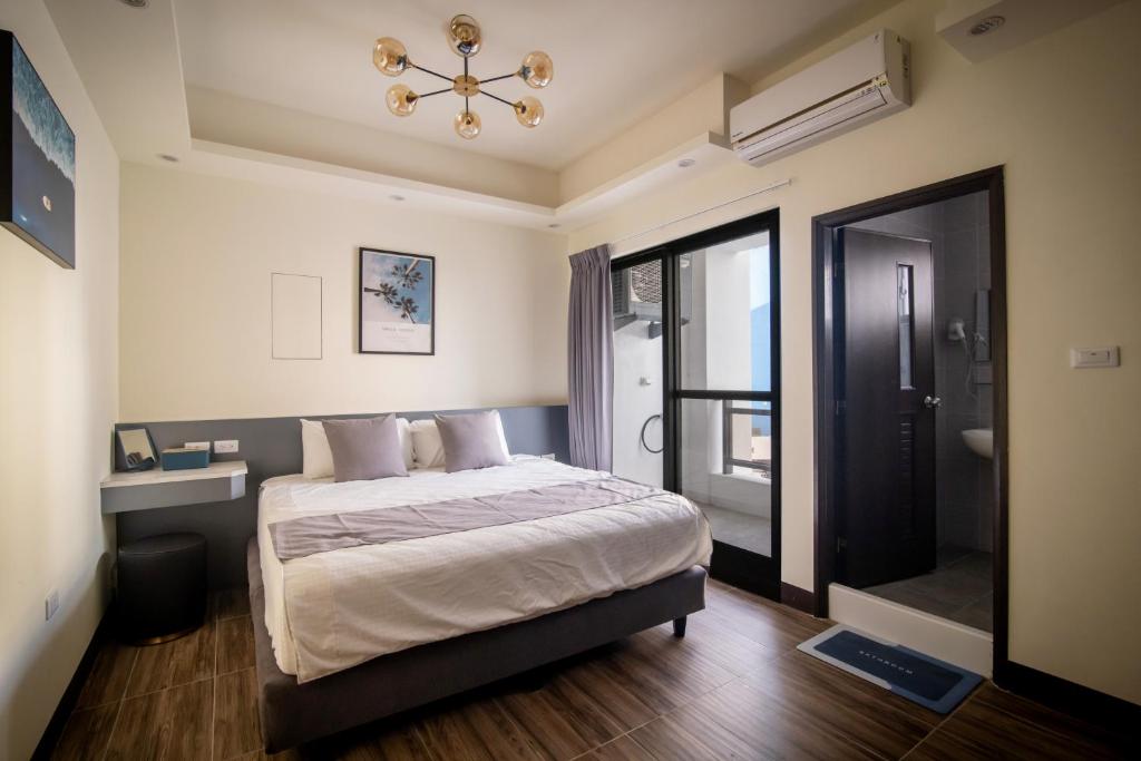 Postel nebo postele na pokoji v ubytování South of Penghu Homestay