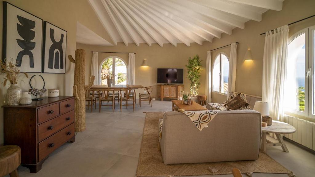 a living room with a couch and a table at Casa Peponi - By Almarina Villas in Jávea