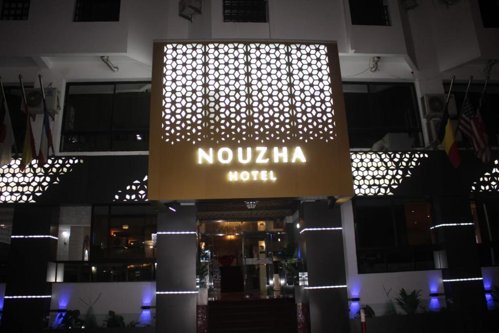 a sign for a nokia hotel in a building at Hotel Nouzha in Fès