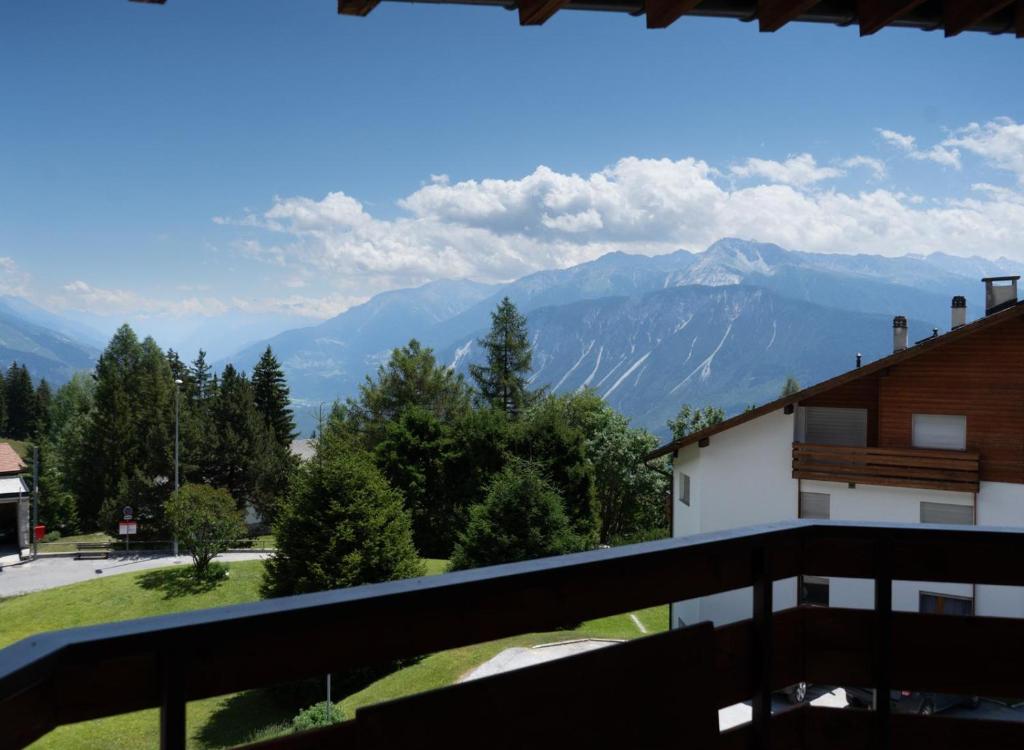 a view of mountains from the balcony of a house at Crans-Montana Les Rocca C in Crans-Montana