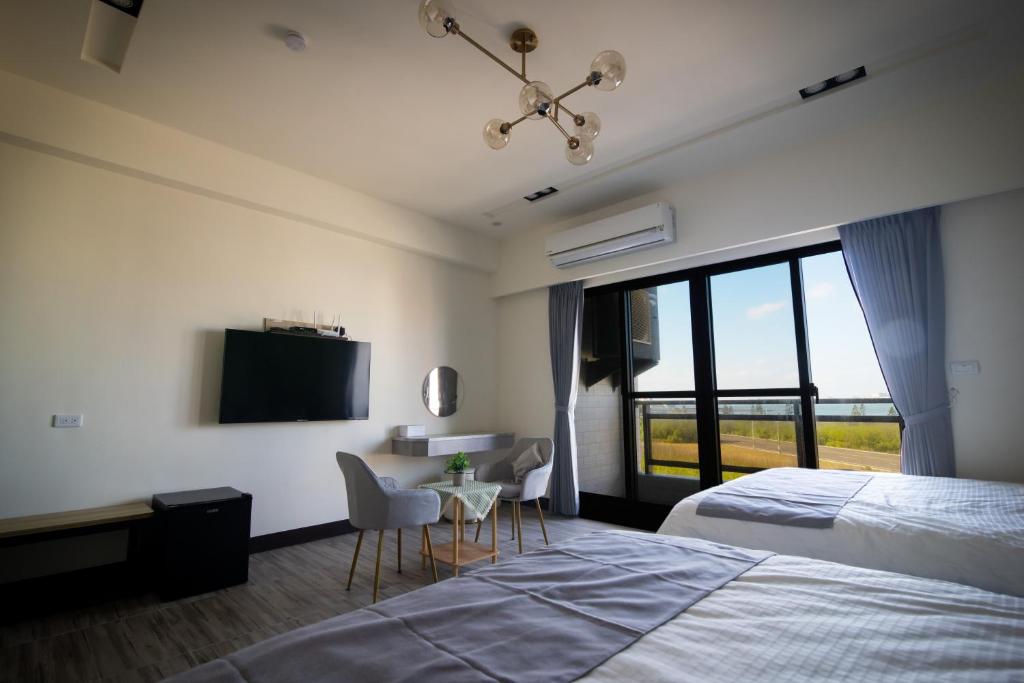 Postel nebo postele na pokoji v ubytování South of Penghu Homestay