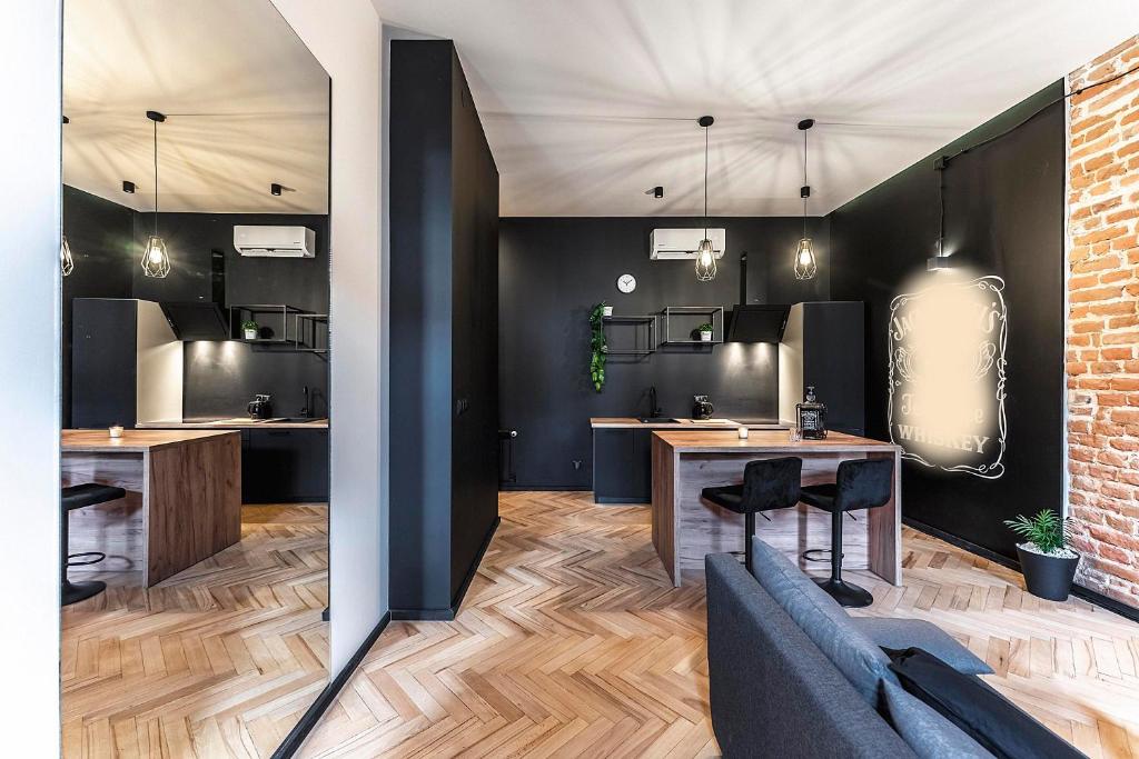 a salon with black walls and wooden tables and chairs at Krakowskie30 Loft2 na deptaku in Lublin