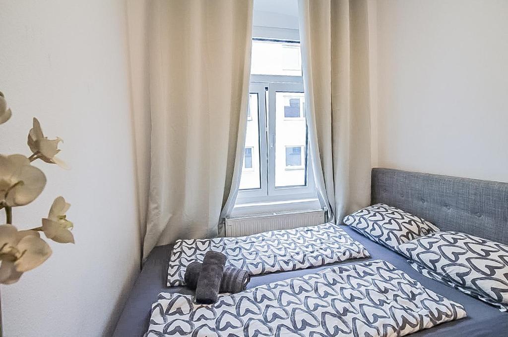 a bedroom with two beds and a window at Premier Double room TH in Vienna