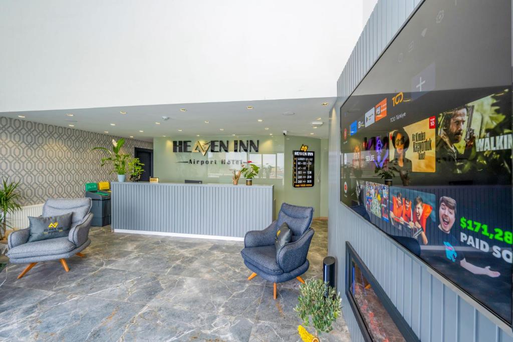 a waiting room with two chairs and a counter at Heaven Inn Airport Hotel in Arnavutköy