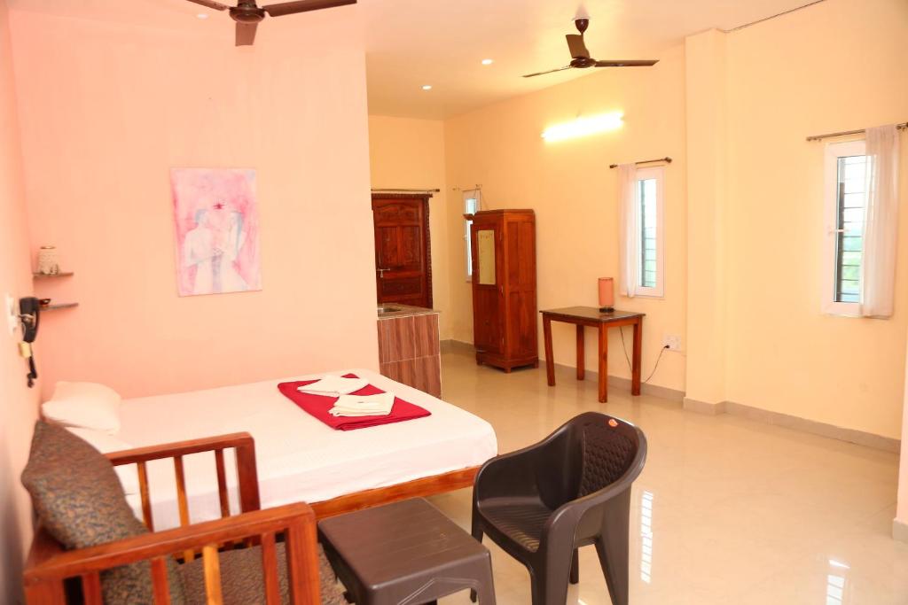 a kitchen and dining room with a table and chairs at Blissful Haven Art House - near entrance to Auroville in Auroville