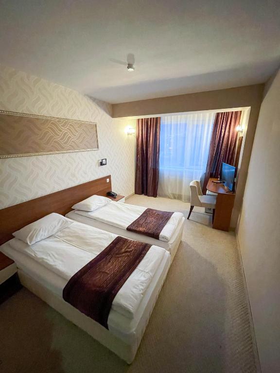 A bed or beds in a room at Hotel Rila