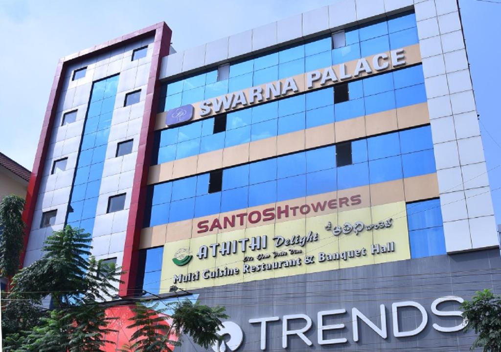 a building with a sign on the side of it at Swarna Palace in Siddipet