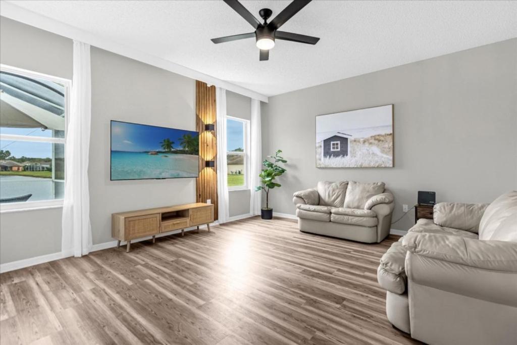 a living room with two couches and a ceiling fan at 4 Bathrooms 3 Bathrooms Cresent Lakes 5305 Cv in Kissimmee