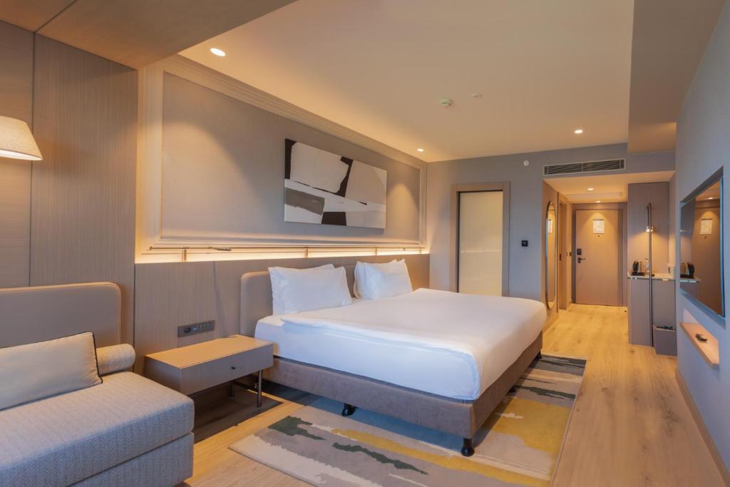 Postel nebo postele na pokoji v ubytování Kolin Hotel Spa & Convention Center