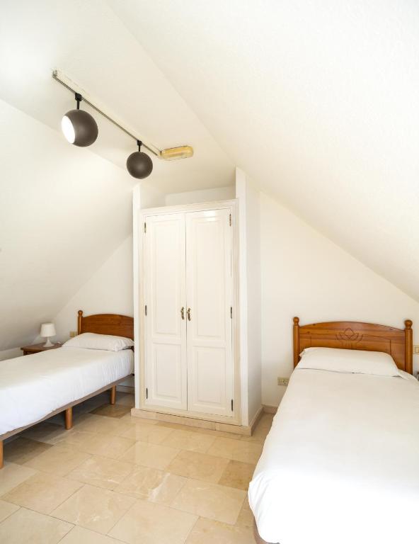 Postel nebo postele na pokoji v ubytování Villas Las Almenas