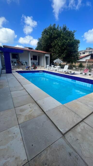 a swimming pool in front of a house at Oásis da Praia in Caucaia