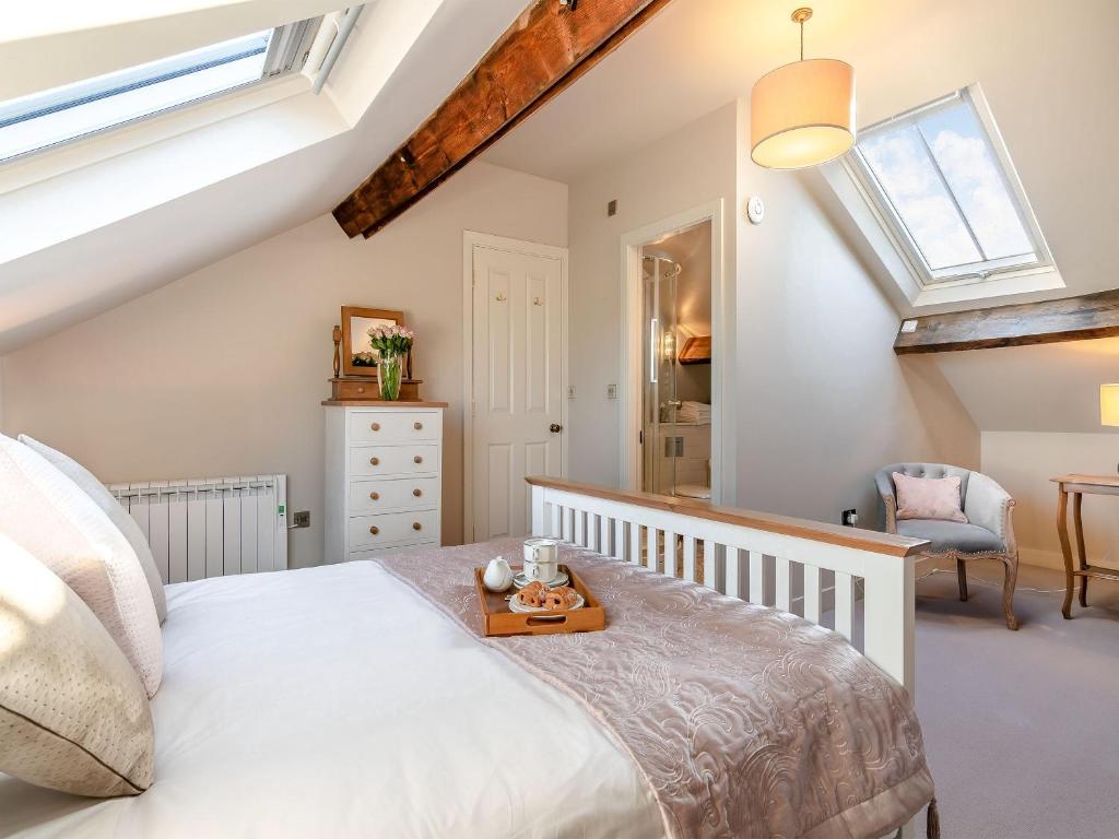 a bedroom with a bed and a skylight at Flat 5, The Lodge in York