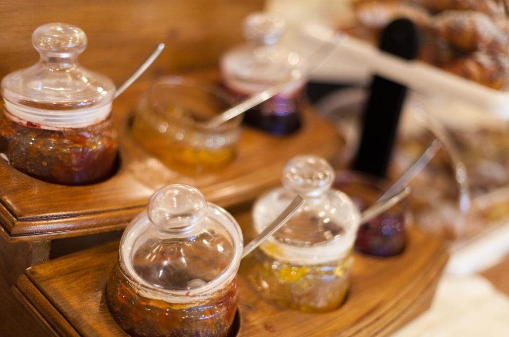 a group of jars of honey on a wooden table at Blue Waves Resort in Malinska
