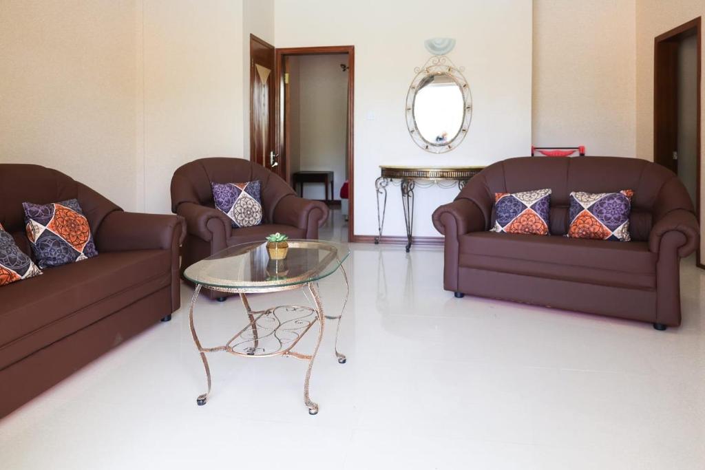 een woonkamer met 2 banken en een tafel bij ibis Apartments - Ground Floor - Summersun Residence - Grand Baie, Pereybere in Grand Baie