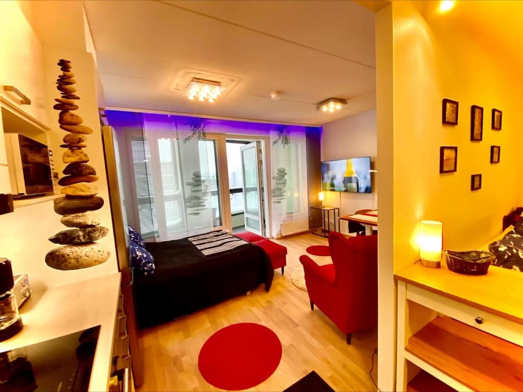 1 dormitorio con 1 cama y 1 silla roja en una habitación en To LuxStudio SAVUsuite From Helsinki Airport 6 min, to City 27min, FreeParking in Kivistö, en Vantaa