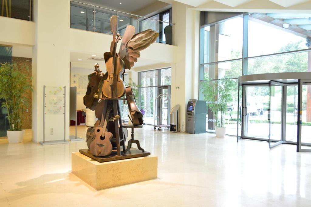 a statue of a person with wings on a stand in a lobby at Flamingo Grand Hotel & Spa in Albena