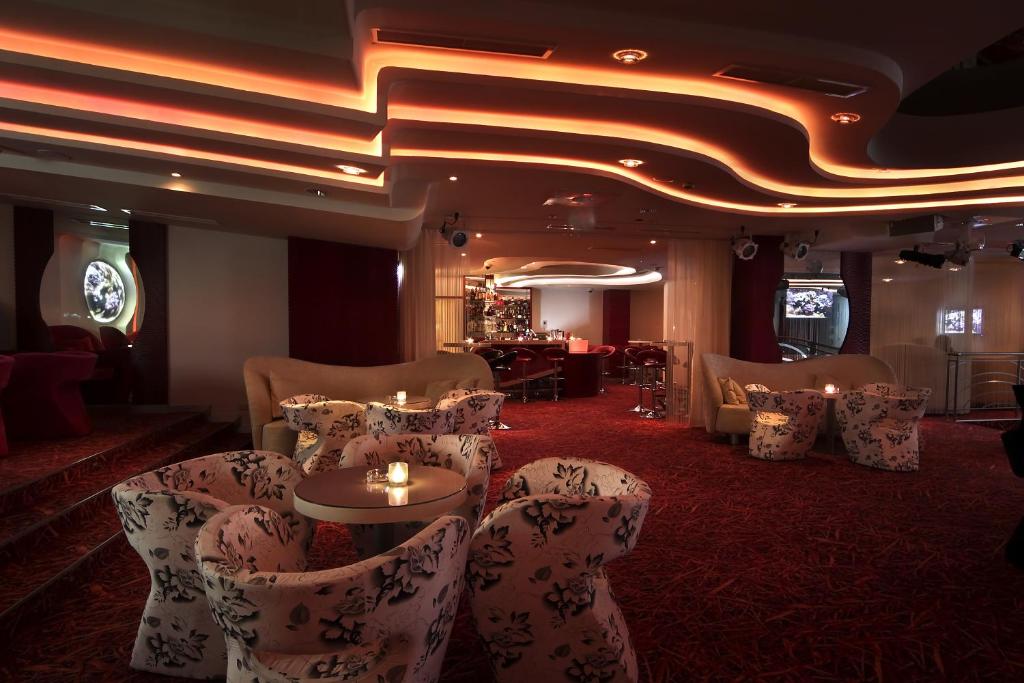 a room with chairs and a table with candles at Flamingo Grand Hotel & Spa in Albena