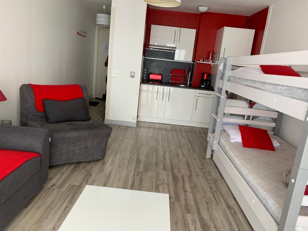 a small living room with a bunk bed and a couch at Studio La Mongie in La Mongie