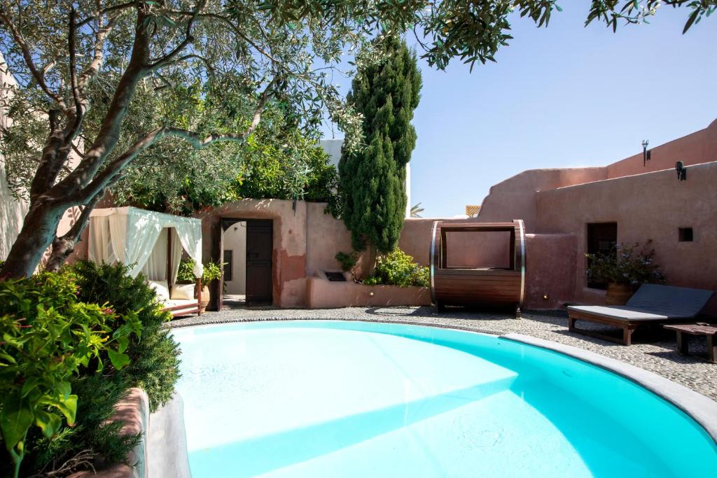 a swimming pool in the yard of a house at Ducato Wine Village in Megalochori