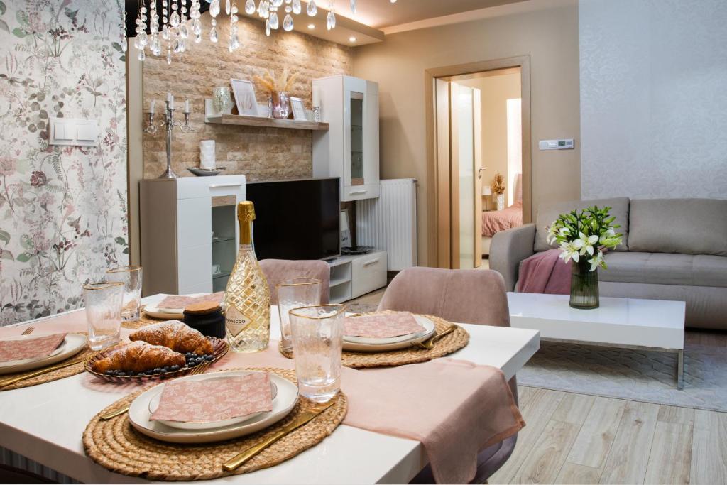 a living room with a table with plates of food at Imádnivaló társasházi lakás in Mosonmagyaróvár