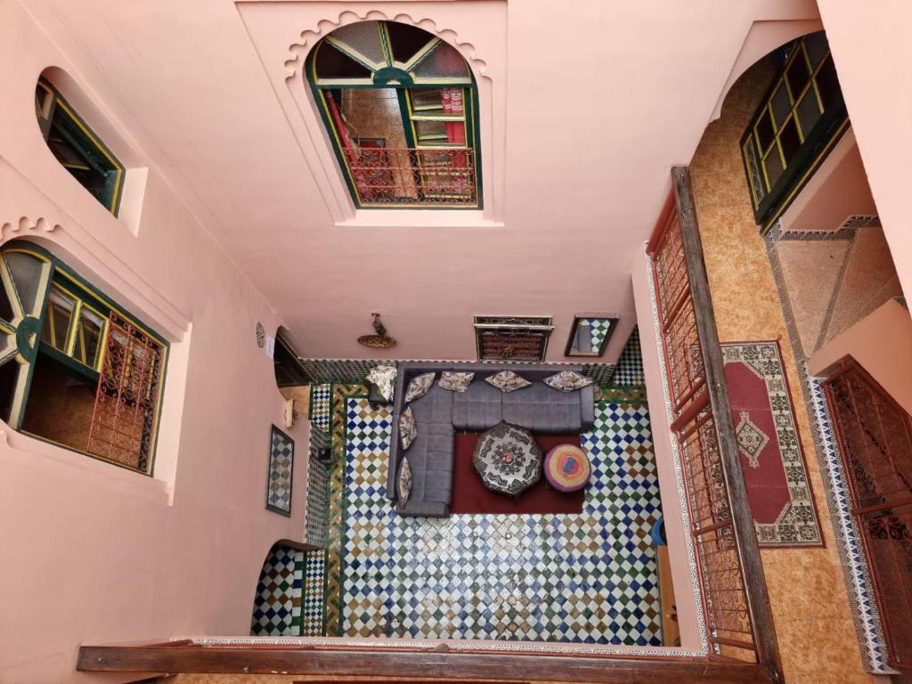 an overhead view of a room with a clock on a wall at Casa del Sol Marrakech in Marrakech