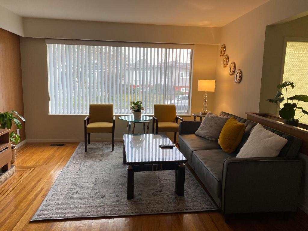 a living room with a couch and a table at 佳佳便利民宿C in Vancouver