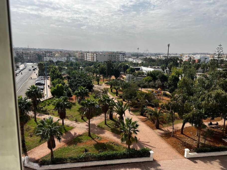 a view of a park with palm trees and a city at Appart à 2 min de Casanearshore in Casablanca