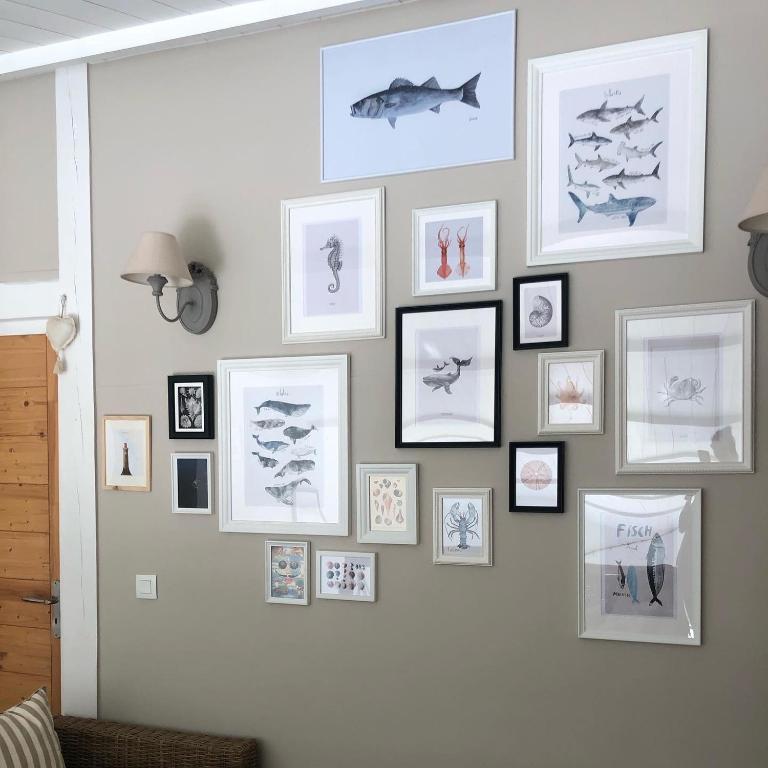 a wall with pictures of fish on it at Villa Pigouille in Sainte-Marie-de-Ré